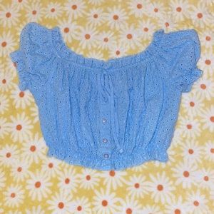 It is in the shade of sky blue it’s a crop top practically brand new never worn